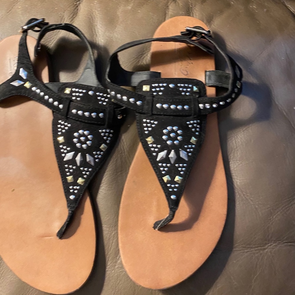 Black flat sandals.